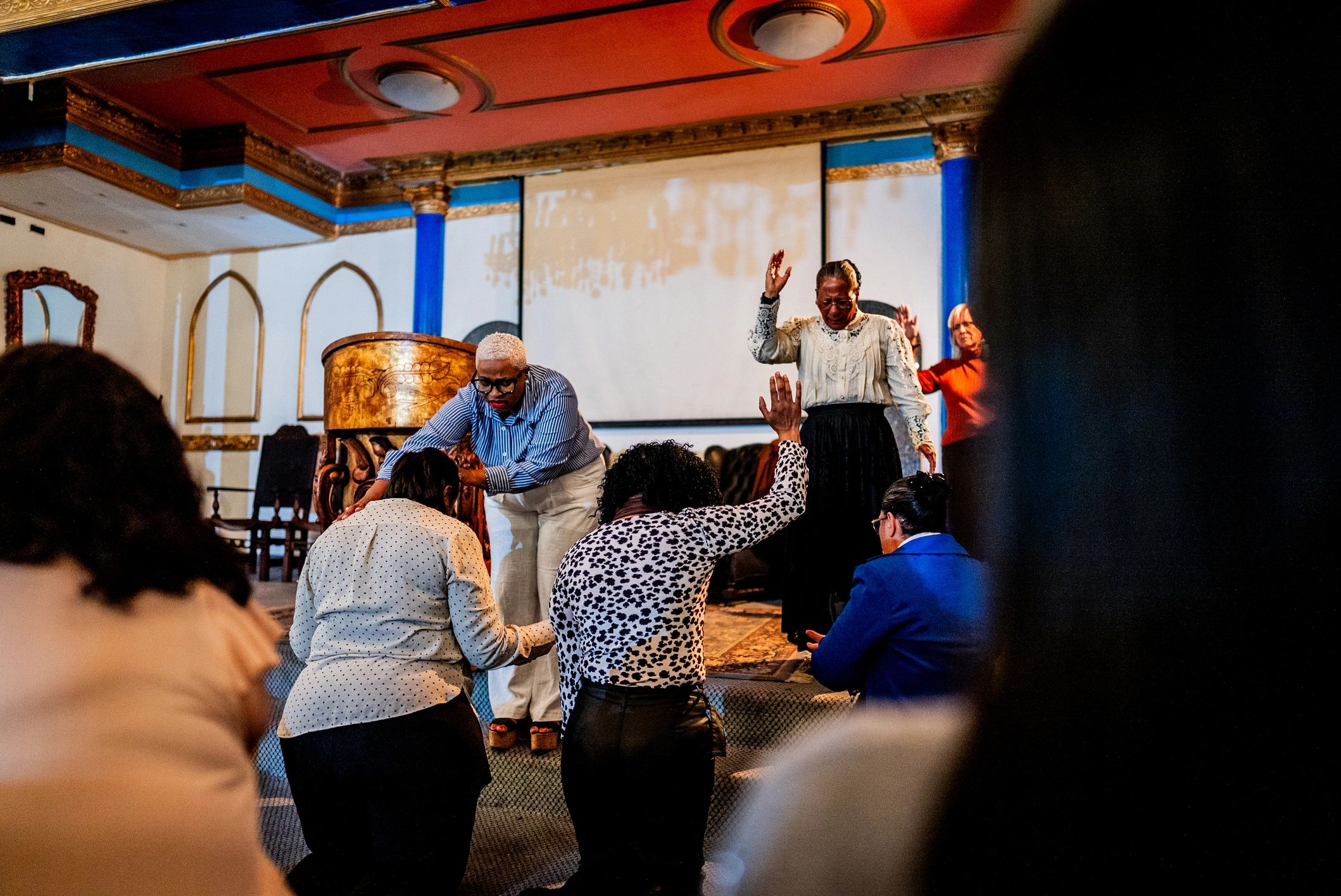 Pastor leading prayer during church service